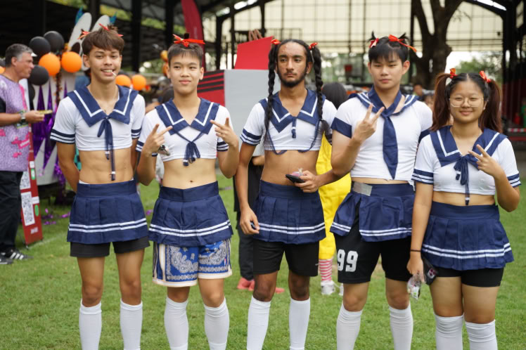 Young student writing on blackboard, practicing occupations in rural classroom setting.