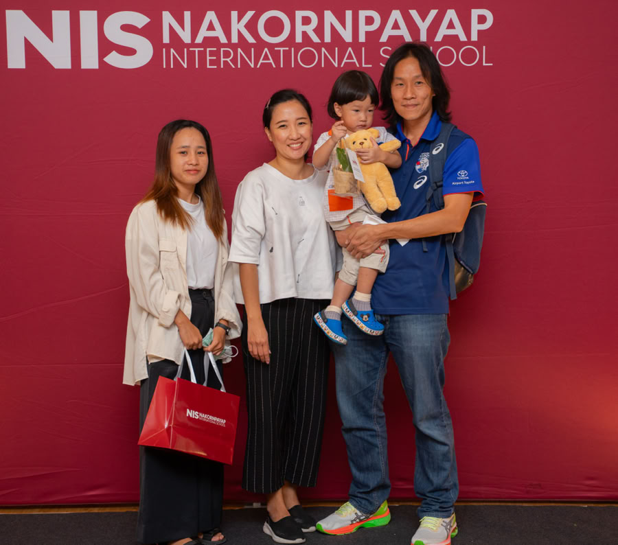 A touching moment between mother and son during graduation day on a sunny outdoor setting.