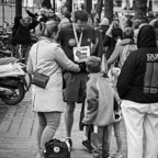 A runner receives congratulations from family after a city marathon.